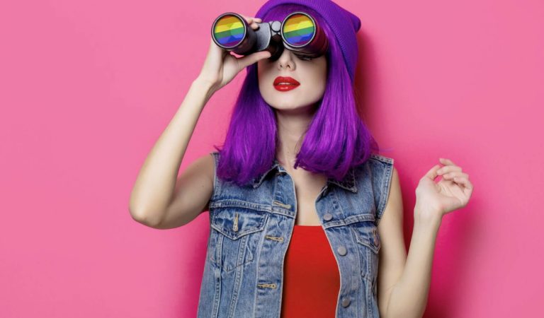 lgbtq single with purple hair using binoculars