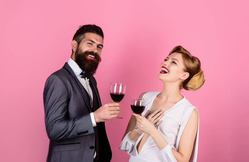 Couple smiling with a cup of wine in a serious relationship