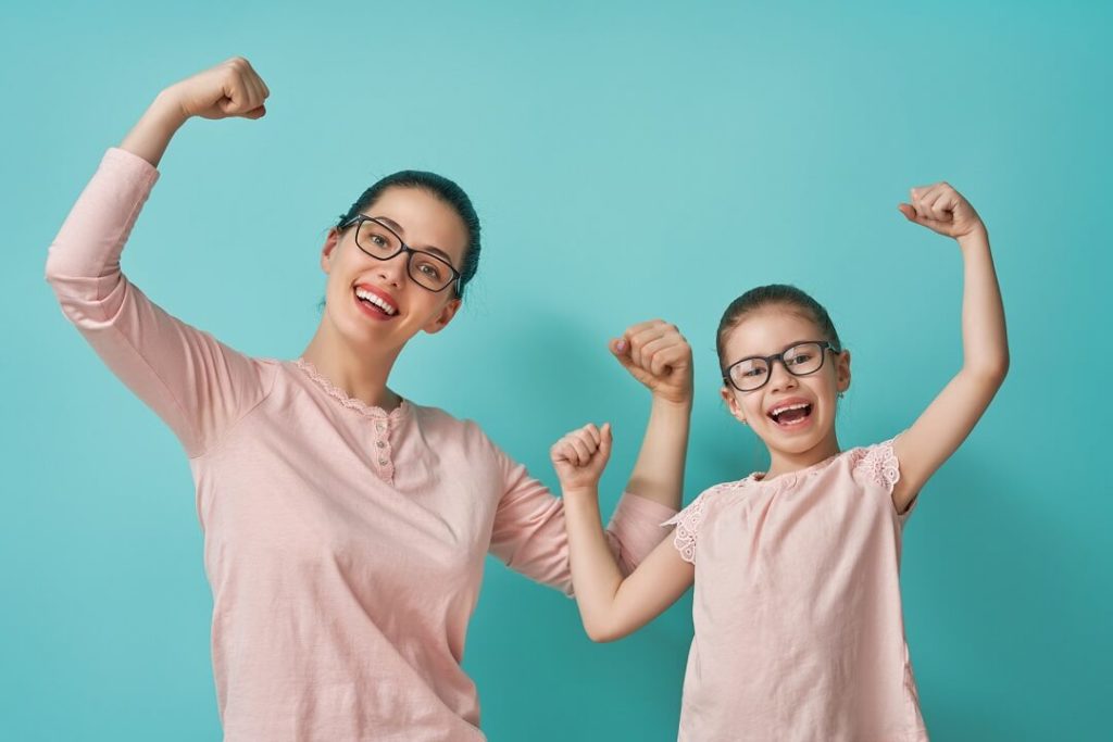 Mom and daughter making strong pose for the camera - single parent dating