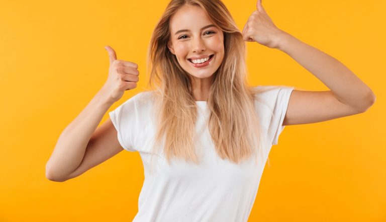 extremely happy deaf girl making thumbs up sign into the camera