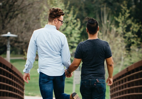 happy couple holding hands while taking a walk