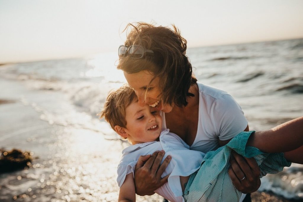 attractive single mum with kid on the beach