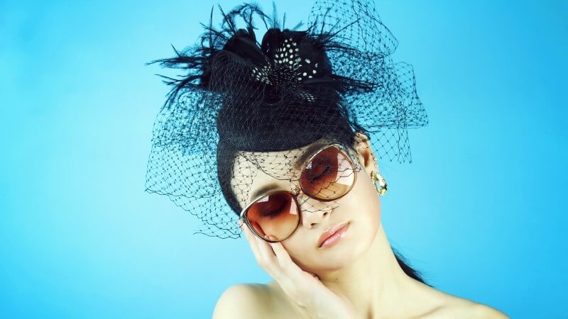 Attractive widow with sunglasses and black hat waiting for a new love