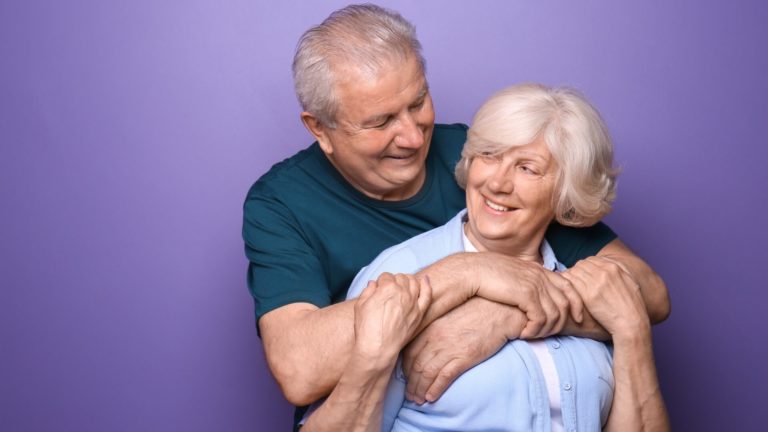 Lovely senior couple hugging from the back