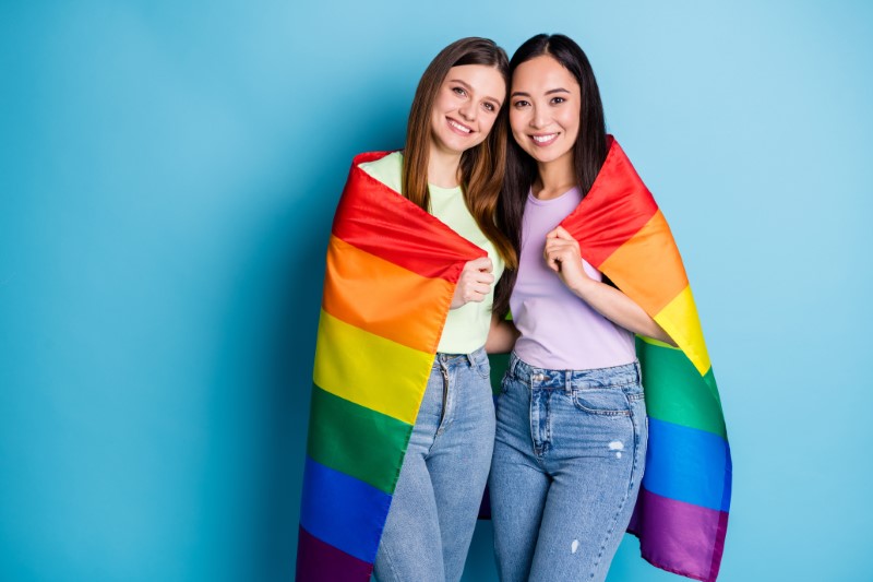 lesbian singles have wrapped a pride flag around each other