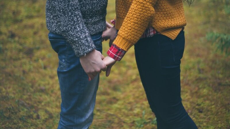 vegan couple holds hands