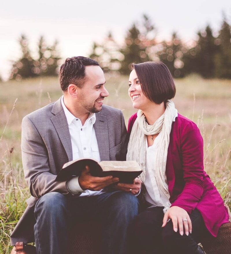 Couple in love reading a Bible together
