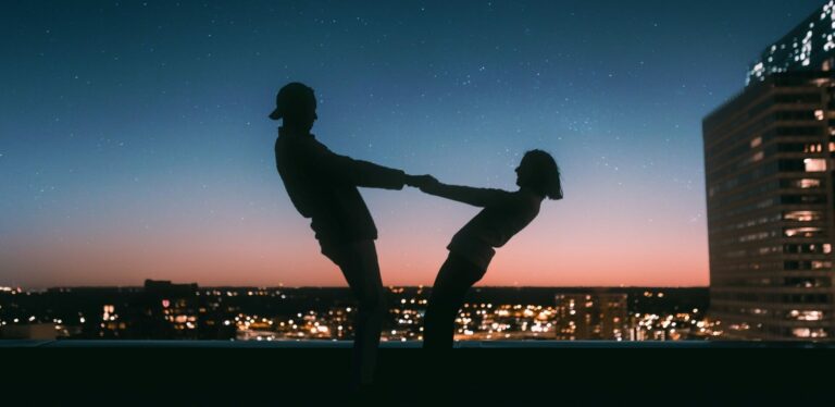 two people dancing under a star sky