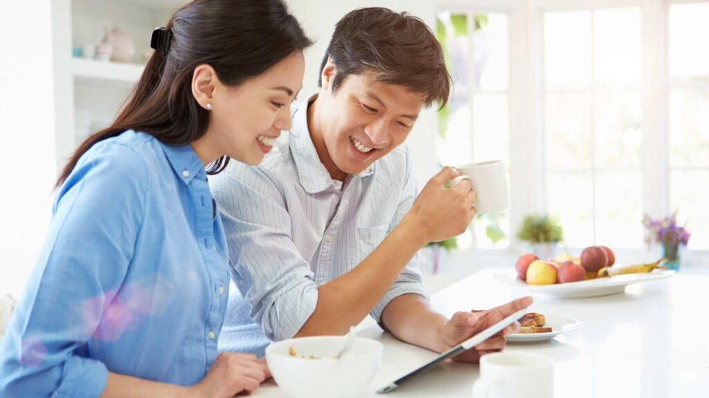 chinese dating married couple enjoying breakfast at home